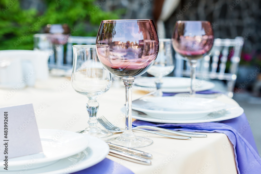 Fototapeta premium Table decorations for holidays and wedding dinner. Table set for holiday, event, party or wedding reception in outdoor restaurant.