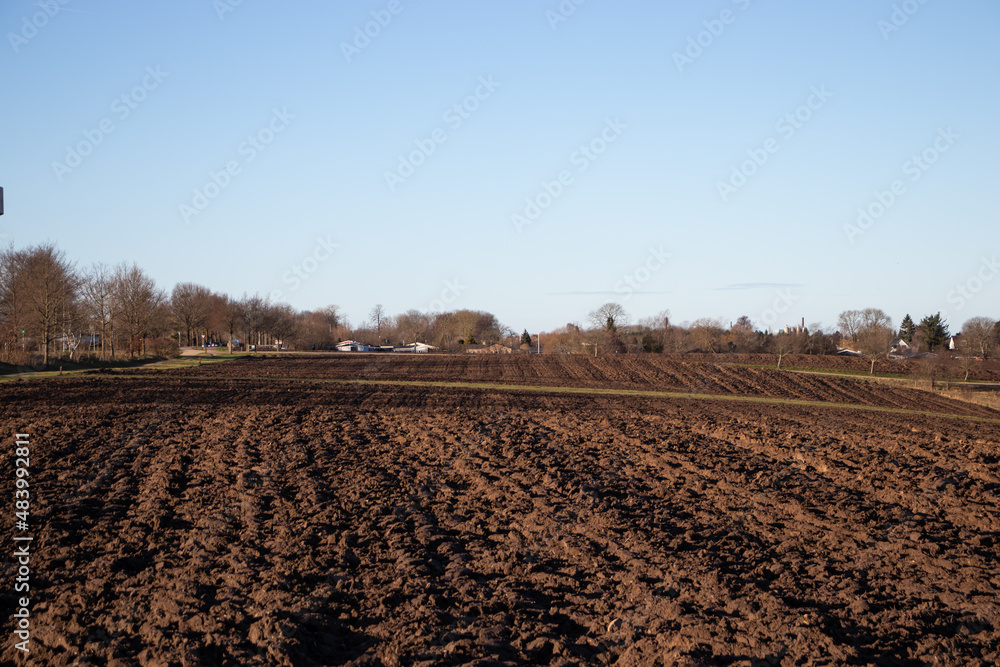 Spring rural landscape. Freshly plowed land. Arable land. Sowing work on the farm.