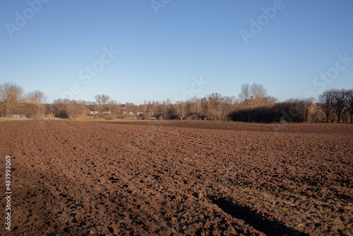Spring rural landscape. Freshly plowed land. Arable land. Sowing work on the farm.