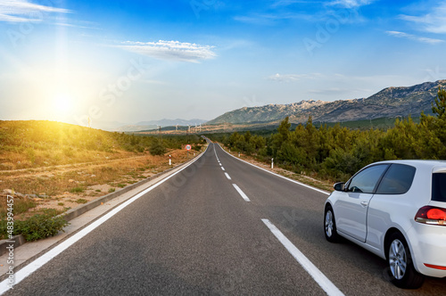 Car on a scenic road. Car on the road surrounded by a magnificent natural landscape.