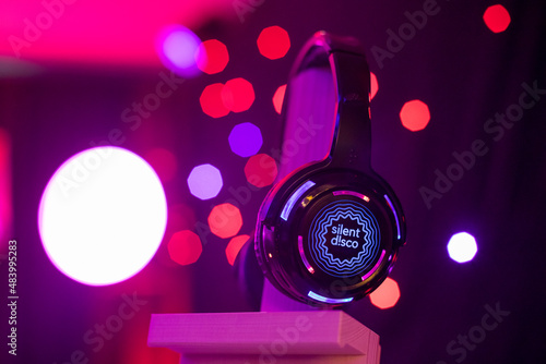 Silent Disco Headphone with red lights shining behind it at an event photo