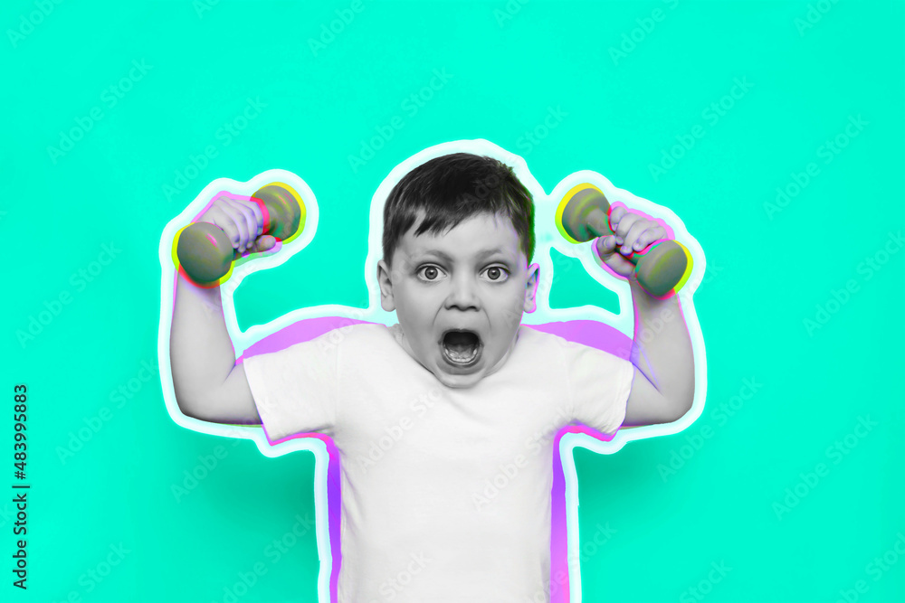Fototapeta premium A little cute kid boy in a white t-shirt with an open mouth demonstrates his strength by raising his hands with dumbbells on bright color green background. Art collage in magazine style. Advertising