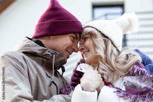 Portrait of two people couple fair-haired woman and man holding crossing hands together staring at each other outdoor
