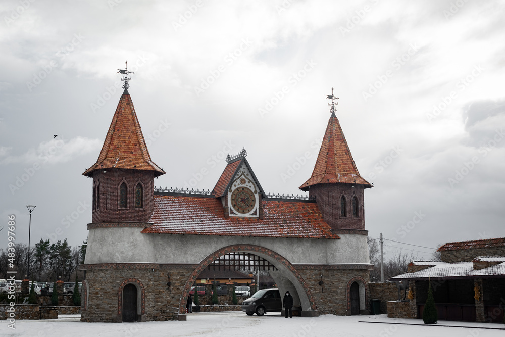 Beautiful stone arch, made of wild stone, with pointed towers, in Gothic style. Architecture of one of the districts of the Rostov region of the Russian Federation.
