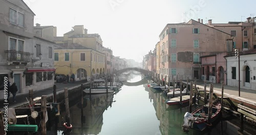 Chioggia town in venetian lagoon, water canal. Chioggia is a seaside town south of Venice, Italy. Traversed by the Corso del Popolo thoroughfare, its historic area has canals and narrow alleys.