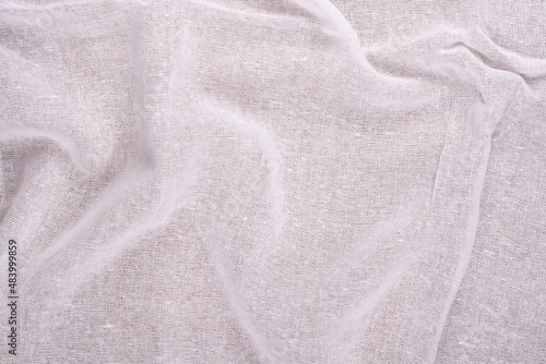 Background of white fabric with folds.