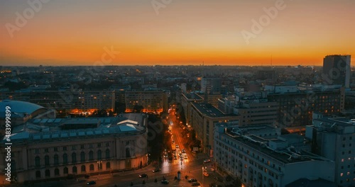 the sun sets over autumn bucharest. evening in a European city. urban active traffic in the old city - Aerial view Hyperlapse photo