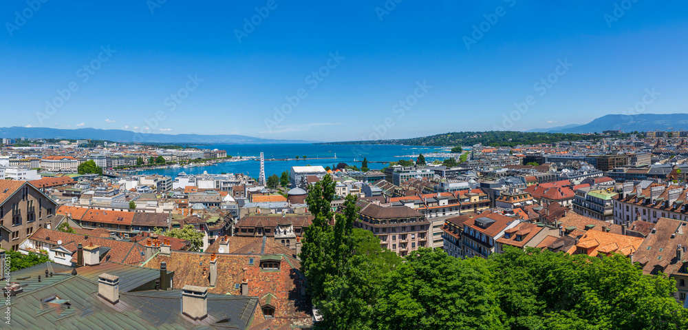 Panoramic city view and Jet d'Eau fountain on Lake Geneva. Taken from St. Peter's Cathedral, Switzerland. The fountain sprays upwards to 120 meters high.