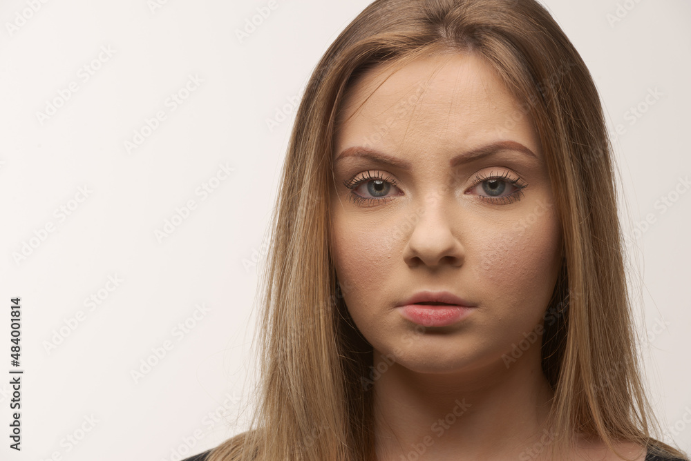 Portrait of sad young woman emotional alone in white background Portrait of sad young woman emotional alone in white background