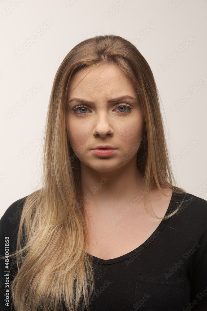 Portrait of sad young woman emotional alone in white background