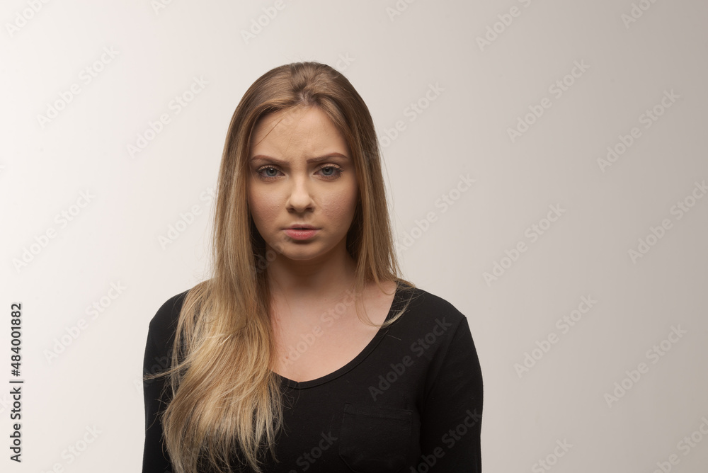 Portrait of sad young woman emotional alone in white background Portrait of sad young woman emotional alone in white background