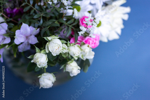 Fototapeta Naklejka Na Ścianę i Meble -  Bouquet of flowers on a blue background