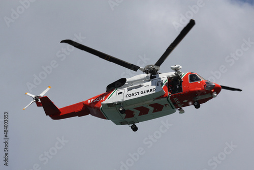 coast guard rescue helicopter in flight with door open photo