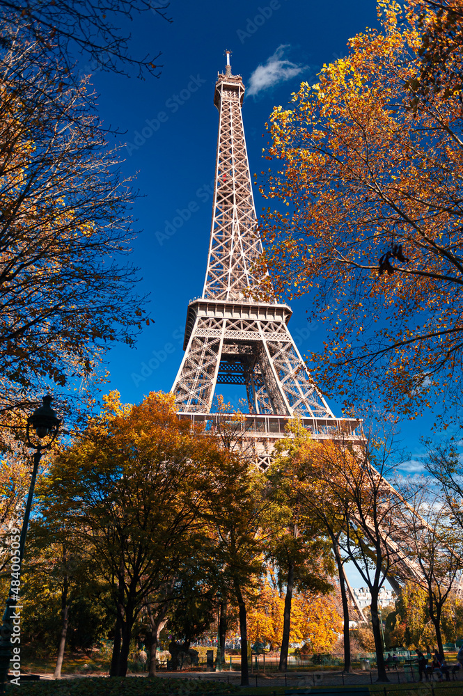 Autumn view to Eiffel Tower in Paris, with amazing colours and blue sky. Travel in France.