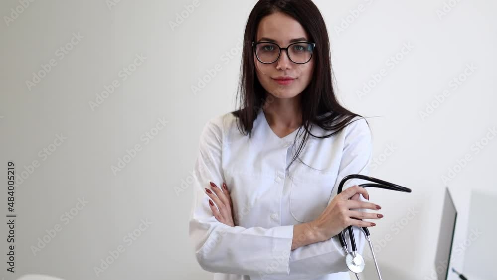 Young female nurse crossing her arms. Portrait of a woman doctor Young female nurse crossing her arms. Portrait of a woman doctor