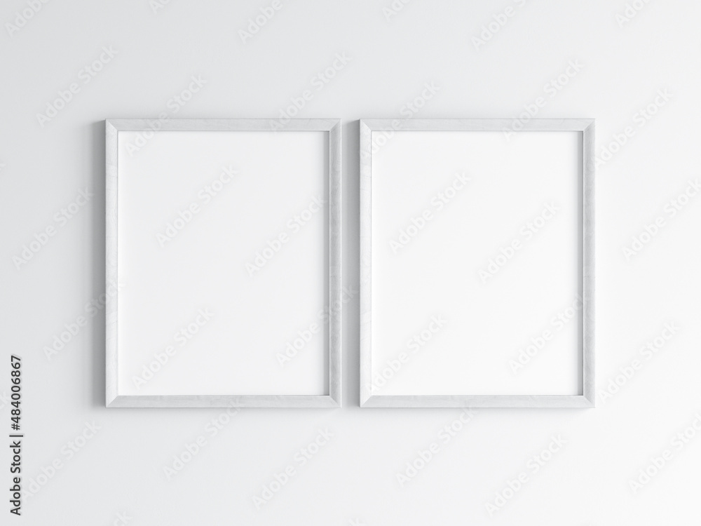 Two white frames on the wall, poster mockup, 3d render Two white frames on the wall, poster mockup, 3d render