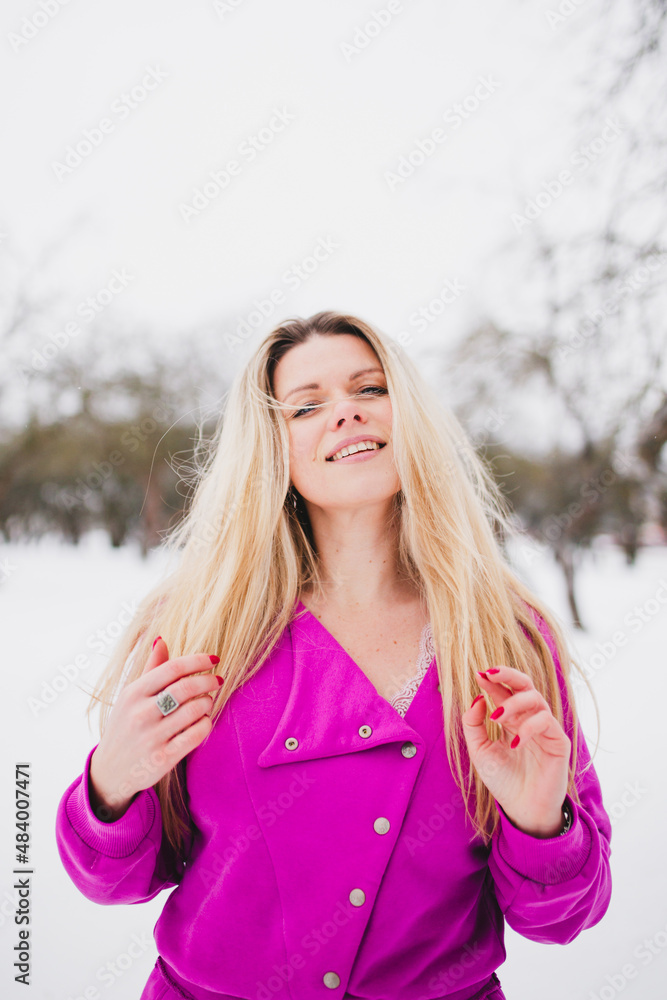 Romantic image of a young attractive woman in the winter in the park - happy emotion on a beautiful face with flowing long hair Romantic image of a young attractive woman in the winter in the park - happy emotion on a beautiful face with flowing long hair