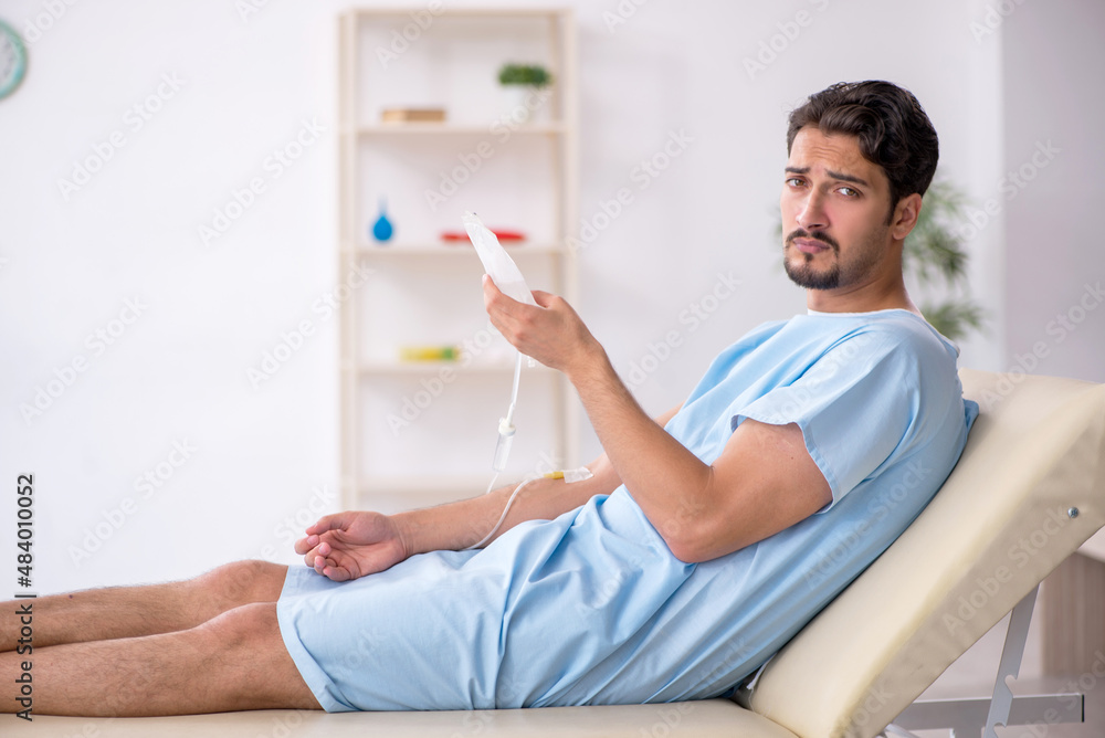 Obraz premium Young male patient in transfusion concept