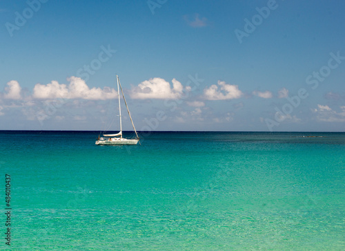 sailboat on the sea beautiful color true horizon puffy white clouds