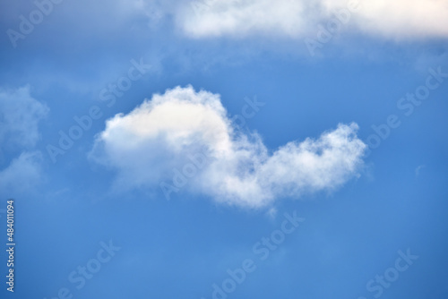 Bright landscape of white puffy cumulus clouds on blue clear sky