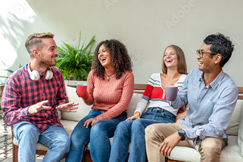 group of friends laughing and drinking coffee, meeting of generation z people, adult student in erasmus, multicultural and biracial people having fun