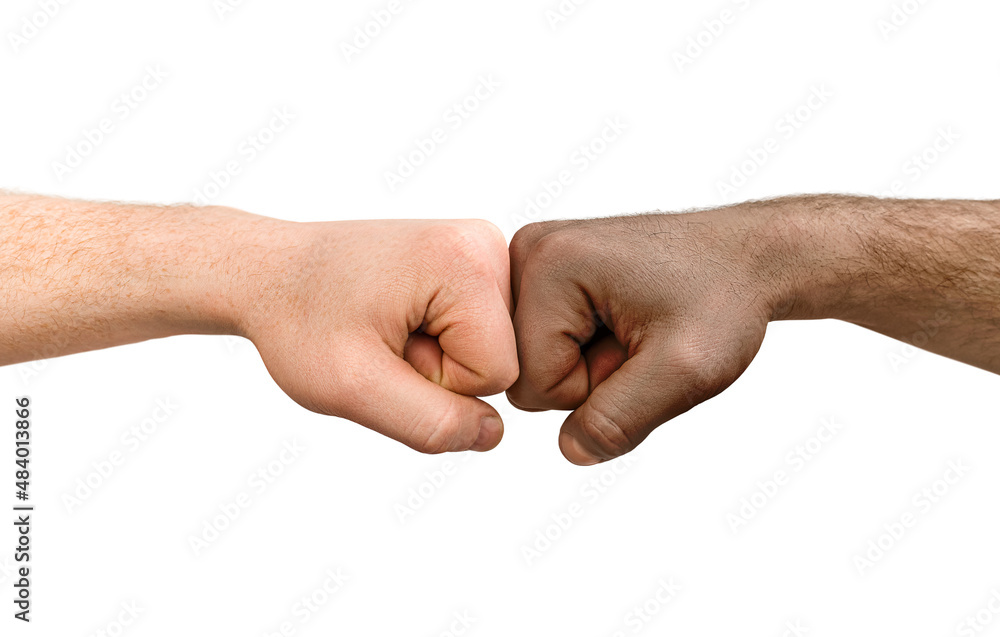 the hand of a white man and an African American are touching fists. on a white isolated background the hand of a white man and an African American are touching fists. on a white isolated background