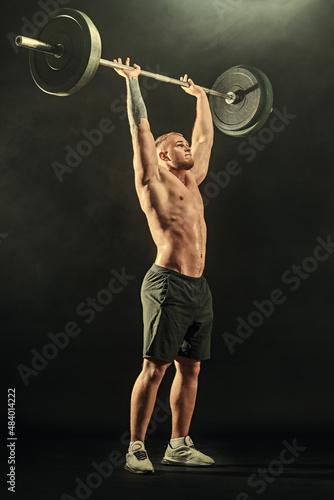 weightlifter lifting a heavy barbell