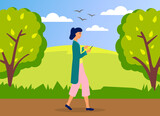 Young woman walking in park with mobile phone using smartphone to share posts in social networks, chatting with friends, sending message. Girl holds smart phone to make repost of video and news
