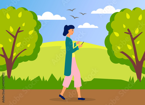 Young woman walking in park with mobile phone using smartphone to share posts in social networks, chatting with friends, sending message. Girl holds smart phone to make repost of video and news
