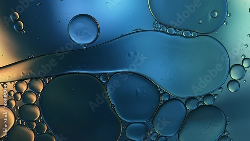 Abstract Colorful Food Oil Drops Bubbles and spheres Flowing on Water Surface, macro Videography