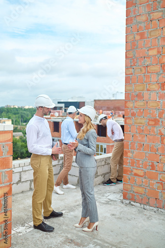 Wallpaper Mural Smiling female supervisor communicating with a foreman outdoors Torontodigital.ca