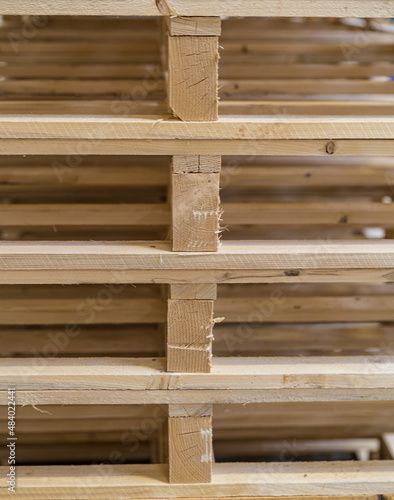 Pallet storage. Big pile. Wooden mountain. The pallets are located in the middle of the warehouse.