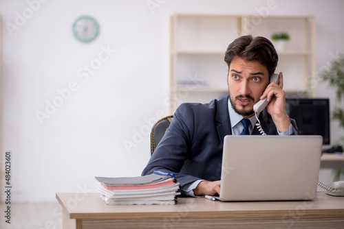 Young male employee working in the office