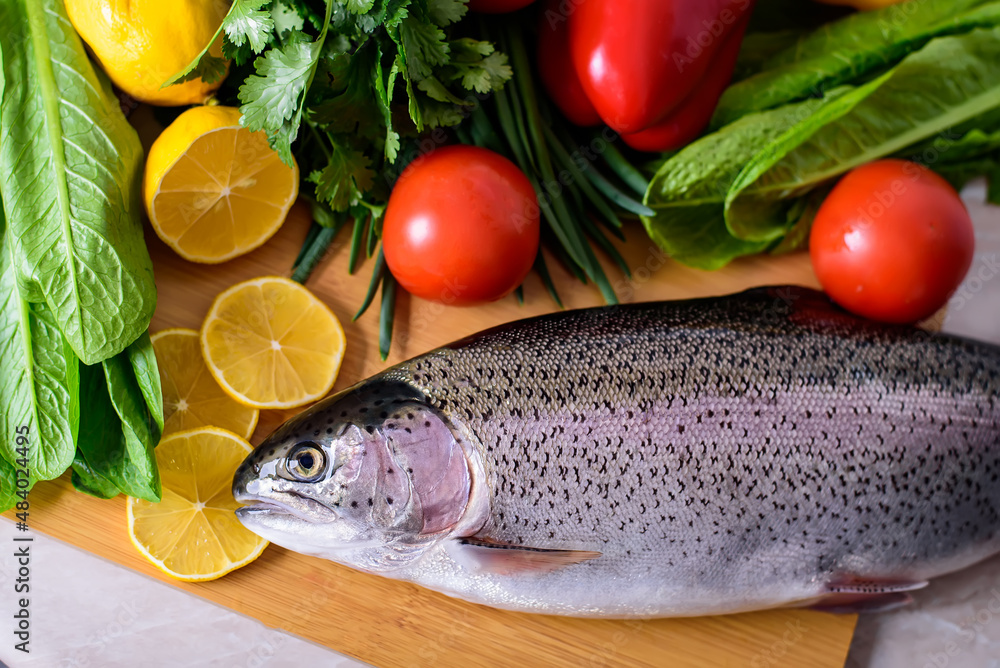 Fresh raw fish and food ingredients on table Fresh raw fish and food ingredients on table