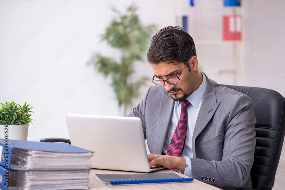 Young male employee working in the office Young male employee working in the office