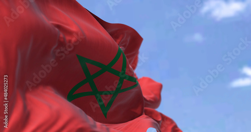 Photos Detail of the national flag of Morocco waving in the wind on a clear day