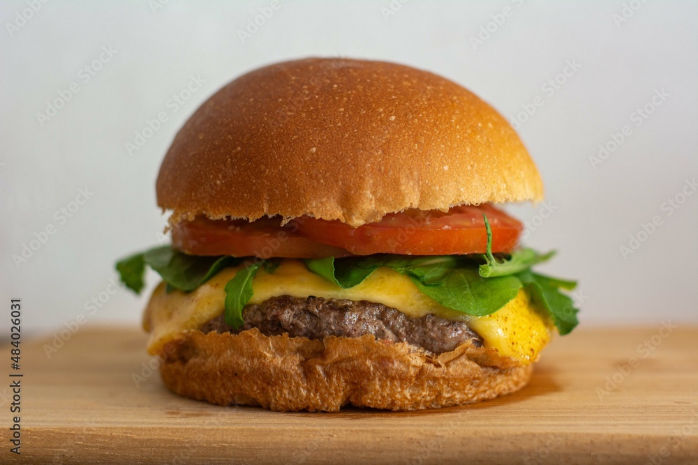 Cheeseburger with bread, tomato, arugula, patty and cheese Cheeseburger with bread, tomato, arugula, patty and cheese