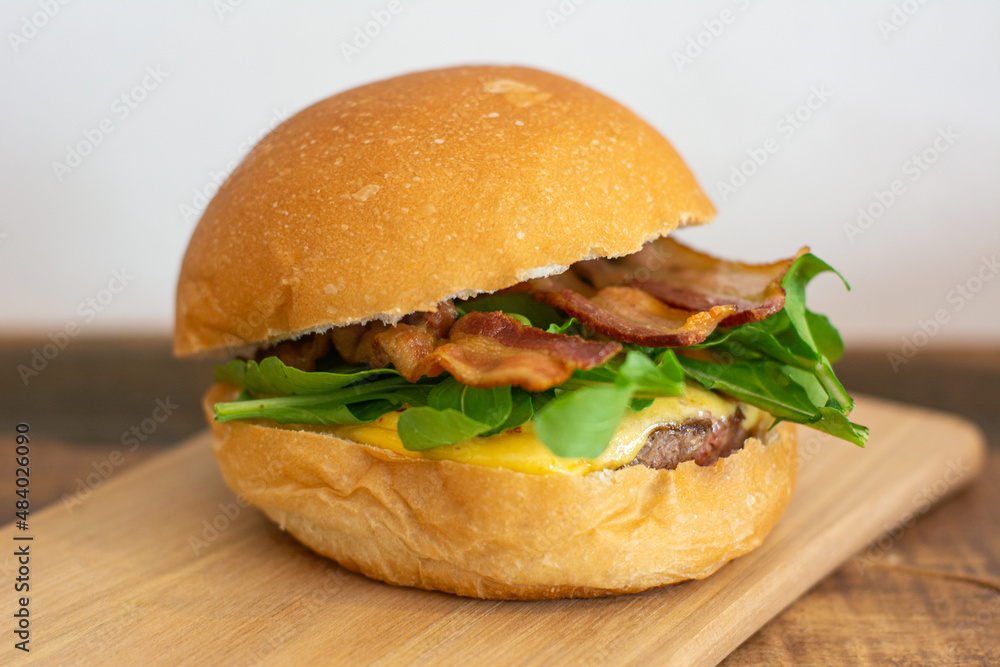 Bacon cheeseburger with bread, bacon, arugula, patty and cheese. Bacon cheeseburger with bread, bacon, arugula, patty and cheese.
