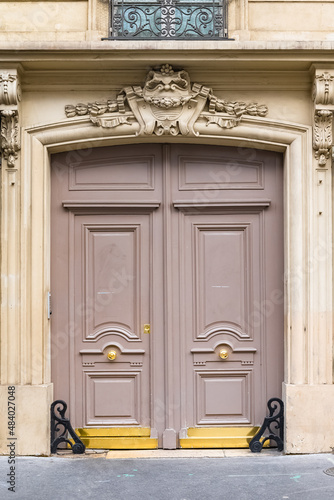 Paris, an ancient door, typical building in the 11e arrondissement
