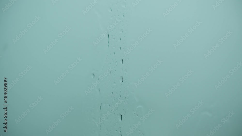 Close-up of water droplets on glass, Rain Rain, Go Away. Large rain drops strike a window pane during a summer shower. 4K. Close-up of water droplets on glass, Rain Rain, Go Away. Large rain drops strike a window pane during a summer shower. 4K.
