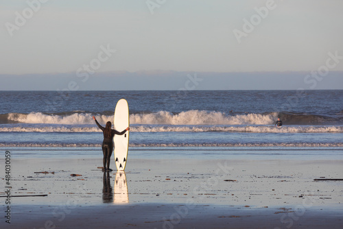 Unrecognizable surfer at the beach of Hendaia, Basque Country.
