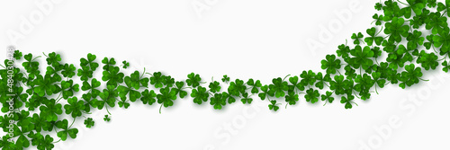 Foto Green flying clover leaves isolated on white background