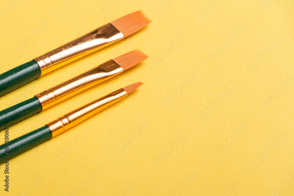 Paint brushes isolated on yellow background. For art Paint brushes isolated on yellow background. For art