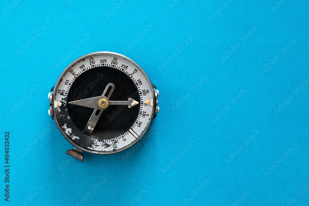 Old soviet compass close-up on a blue background top view isolated mockup Old soviet compass close-up on a blue background top view isolated mockup