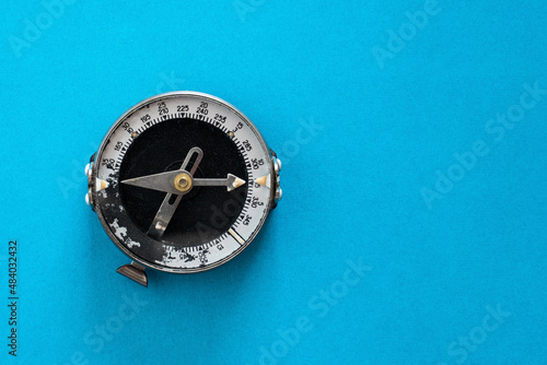 Old soviet compass close-up on a blue background top view isolated mockup