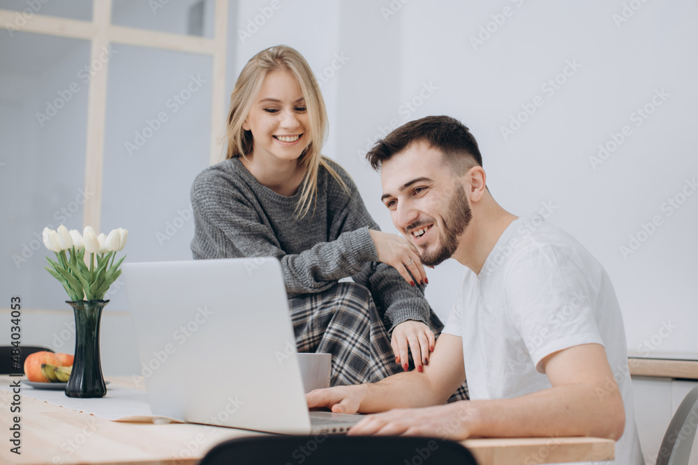 Young couple having a romantic breakfast at home in the kitchen Young couple having a romantic breakfast at home in the kitchen