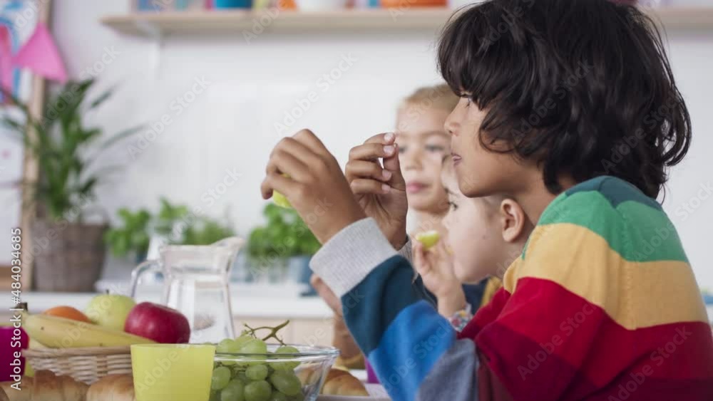 Pre school kids eating snack indoors at nursery school Pre school kids eating snack indoors at nursery school