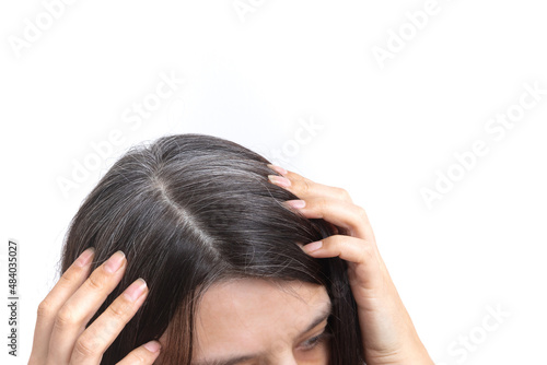 Head of a woman with graying hair on a white background. The concept of early gray hair
