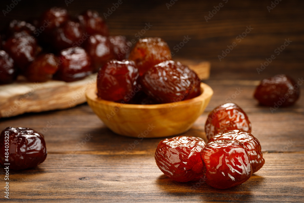 Dried dates fruit on a old wooden table. Arabian food. Dried dates fruit on a old wooden table. Arabian food.