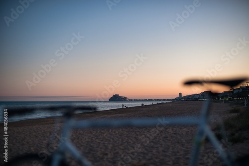 Beach landscape in Peniscola at winter sunset in the sand. Restored classic bike. vintage